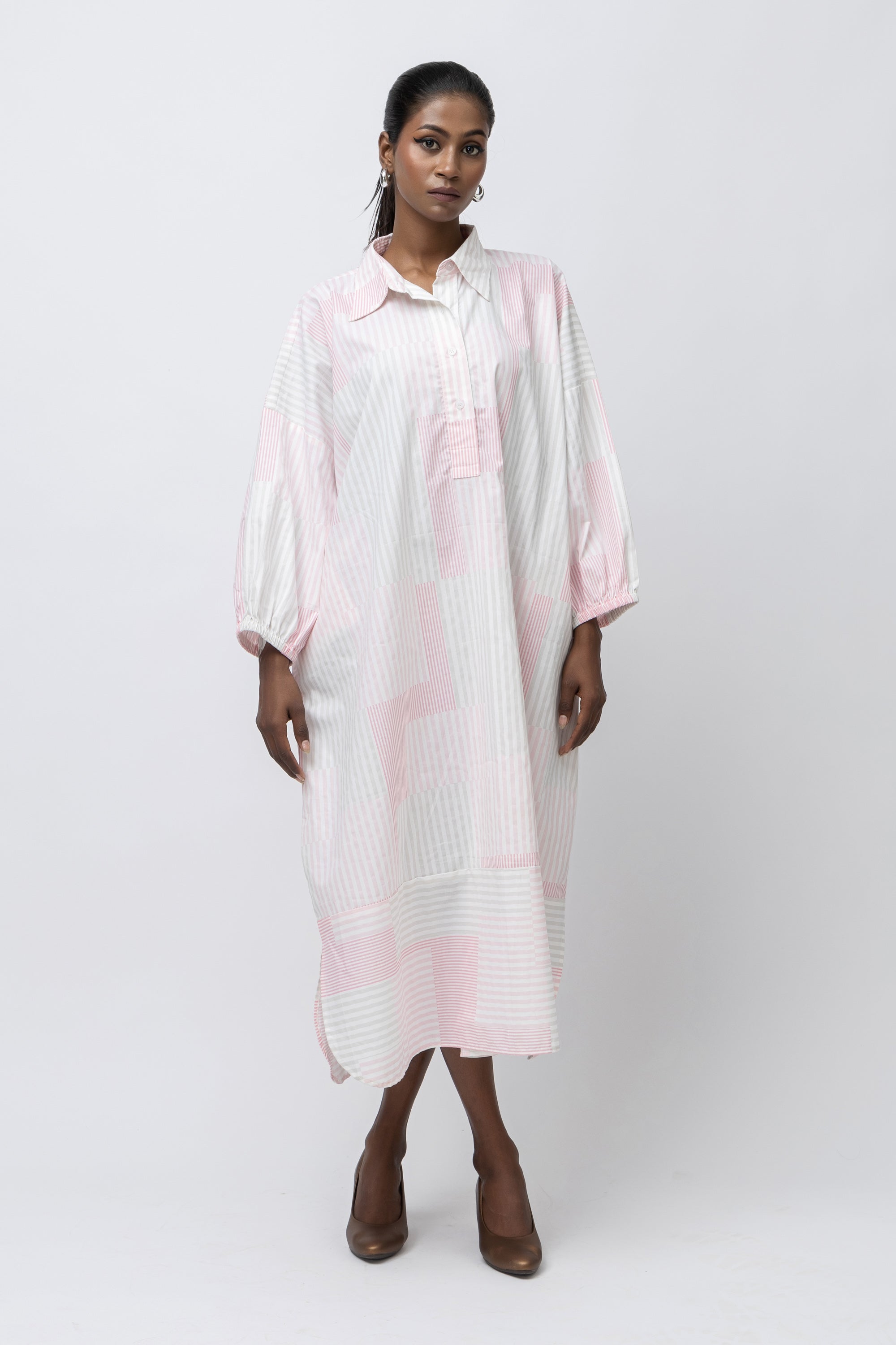 Designed for ease and defined by fabric, the Stripe Kaftan Shirt is crafted in 100% pure cotton for breathable comfort and quiet elegance. The relaxed, fluid silhouette features a dropped-shoulder construction that allows natural movement with an effortless drape.
